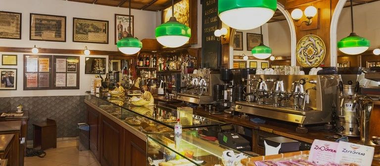 Barista preparing espresso drinks in a specialty coffee shop